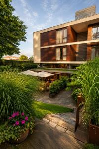a building with a patio and some plants and flowers at Hotel Jaizkibel in Hondarribia