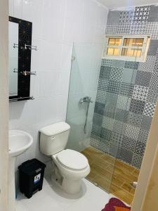 a bathroom with a toilet and a glass shower at Apartment Ñ4 in La Grúa