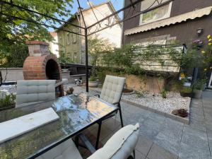 a patio with a table and chairs and a brick oven at Dürschgangs Zimmer in Siegen
