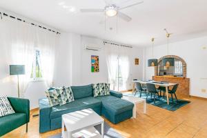 a living room with a couch and a table at Casa Verdejo in Cómpeta