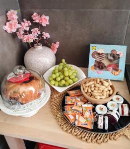 a table with a plate of food and a plate of snacks at Casa 1895 , Boutique Stay in a Historic Townhouse near the Beer Fountain in Žalec