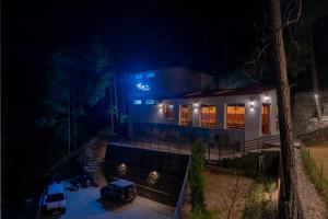 a house lit up at night with lights at BluSalzz Escapade Resort Lansdowne in Lansdowne +43 photos