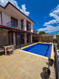 a villa with a swimming pool and a house at Comfy Villa Ipek with Pool in Kaş