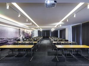 an empty room with rows of desks and chairs at Ibis Styles Heraklion Central in Heraklio