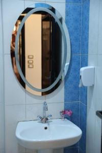 a bathroom with a sink and a mirror on the wall at Hotel G in Sūhāj