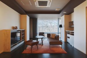 a living room with a couch and a table at KANAYA RESORT HAKONE in Hakone
