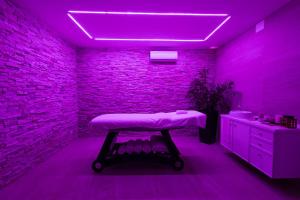 a purple room with a table in the middle of a bathroom at Masseria Tenuta Specolizzi in Lido Marini +42 photos