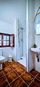 a bathroom with a shower and a toilet and a sink at Rezen Villas in Lorca +12 photos
