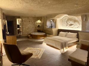 a bedroom with a bed and a bath tub at Miras Hotel in Göreme