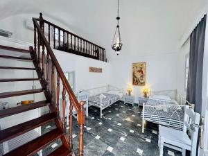 a room with a staircase and a living room at Tritonas Rooms in Kamari +74 photos