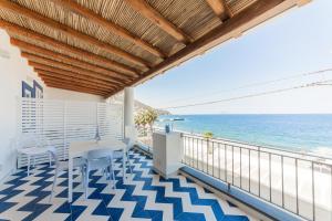 a balcony with a view of the ocean at Archi Suite Canneto in Canneto