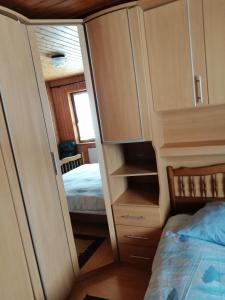 a bedroom with a bed and a cupboard and a bed at Le Paradis du Chalet Perce-Neige in Châtel-Saint-Denis +6 photos