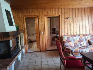 a living room with a couch and a fireplace at Le Paradis du Chalet Perce-Neige in Châtel-Saint-Denis
