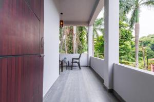 a hallway of a house with a table and chairs at Nitz the loft in Pondicherry