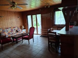 a living room with a table and chairs and a couch at Le Paradis du Chalet Perce-Neige in Châtel-Saint-Denis
