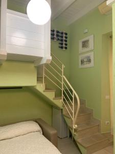 a bedroom with a staircase with a bed and a light at B&B Verde Pastello in Pianopoli
