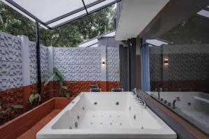 a large bath tub in a bathroom with two sinks at Nitz the loft in Pondicherry
