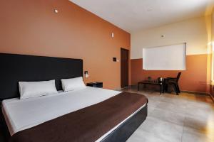 a bedroom with a large bed and a screen at Nitz the loft in Pondicherry +10 photos