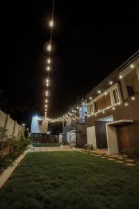 a house lit up at night with lights at Nitz the loft in Pondicherry
