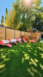 a group of chairs sitting on the grass in a yard at Mougins Centre - Bastide pierre rénovée spa et piscine privé in Mougins