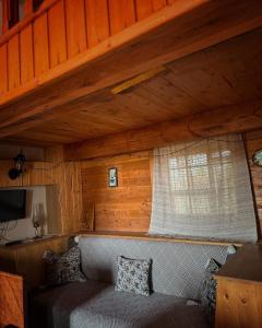 a living room with a couch and a window at Chalet Gyumri in Gyumri +11 photos