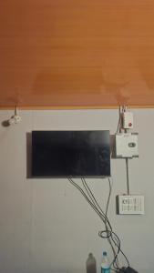 Ein Computermonitor an einer Wand mit einem Holzsims in der Unterkunft Bambooleaf pool dormitory in Meppādi
