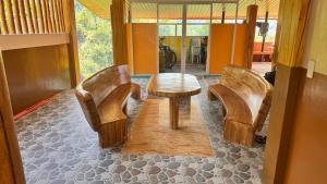 a table and two chairs in a room at Cliffhouse Kalinga in Tinglayan