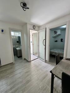 a room with a hallway with a bedroom and a mirror at "DOMUS LEONE" - Nel Borgo di Capri Leone in Capri Leone +13 photos