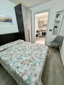 a bedroom with a bed and a chair in it at "DOMUS LEONE" - Nel Borgo di Capri Leone in Capri Leone