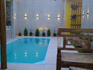 a swimming pool in a building with a bench at Pousada Mandala in Palmeiras +14 photos