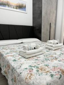 a bedroom with a bed with towels on it at "DOMUS LEONE" - Nel Borgo di Capri Leone in Capri Leone