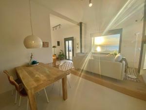 a living room with a table and a couch at The Izi House in Egina