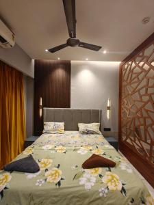 a bedroom with a large bed with flowers on it at Darshana Studios#Galaxyblue sapphire#Stylish in Ghaziabad