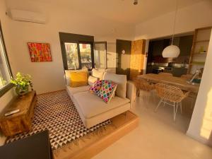 a living room with a couch and a table at The Izi House in Egina