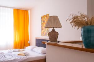a hotel room with a bed with a lamp on it at Rron's House in Prizren
