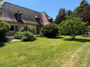 a house with a yard with grass and trees at Le Clos Périgourdin in Église-Neuve-de-Vergt +13 photos