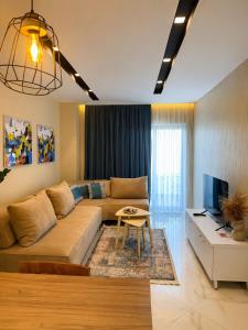 a living room with a couch and a table at Nova Apartaments Qerret ZL in Golem