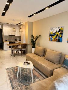 a living room with a couch and a table at Nova Apartaments Qerret ZL in Golem