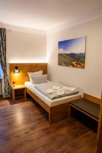 a bedroom with a bed and a picture on the wall at Hotel Restaurant St. Germanshof in Bobenthal