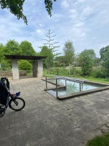 a bike parked next to a pool of water at Ferienwohnung Neumann in Lentföhrden