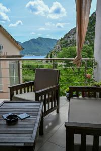 a balcony with a table and chairs and a view at Apartman Darija 3 in Gornji Orahovac