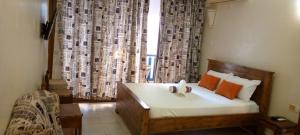 a bedroom with a bed in front of a window at Heaven place -1 bedroom beachfront unit in Ukunda