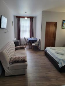 a living room with a couch and a bed and a table at Guesthouse Vashlovani in Lagodekhi +114 photos