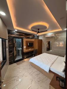 a bedroom with a large bed and a bathroom at Oaktel Jagannath Dham in Vrindāvan