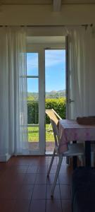a room with a table and a window with a view at Residence Casali Romei in Sarzana
