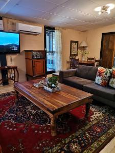a living room with a couch and a coffee table at De Oude Schuur in Stellenbosch +71 photos