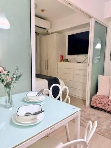 a room with a table and chairs and a bedroom at SM Bicutan Quick Staycation PH in Manila