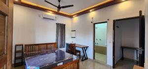 a room with a bed and a desk and a mirror at Pearl's Lake House in Cochin