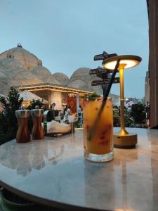 a table with a drink sitting on top at OROM PONORAMA VIEW old city in Bukhara