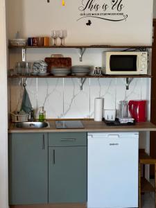 a kitchen with a sink and a microwave at Apartments Rubis in Rovanjska